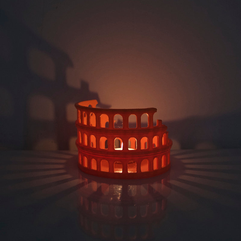 Colosseo Candle Holder casting arches and shadows on table